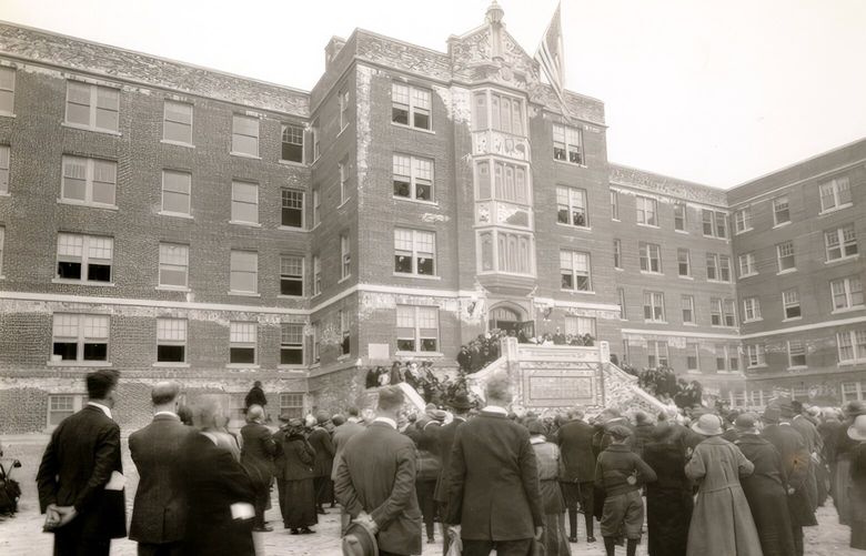 THEN: Celebrants gather at the front (east) entrance of St. Vincent Home for the Aged on April 26, 1924. The stairway and cross were removed in a mid-1960s rebuild.