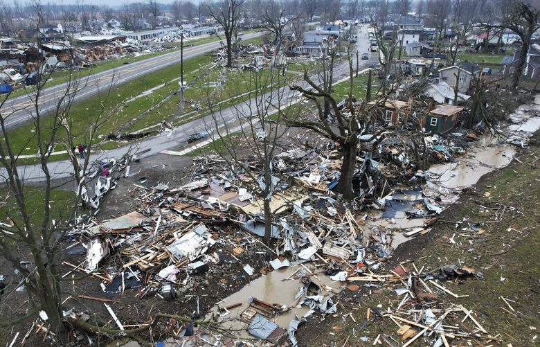 Debris scatters the ground near damaged homes following a severe storm Friday, March 15, 2024, in Lakeview, Ohio. (AP Photo/Joshua A. Bickel) CLI111 CLI111