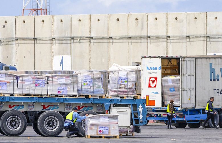 Trucks carrying humanitarian aid for the Gaza Strip pass through the inspection area at the Kerem Shalom Crossing in southern Israel, Thursday, March 14, 2024. (AP Photo/Ohad Zwigenberg) XOB109