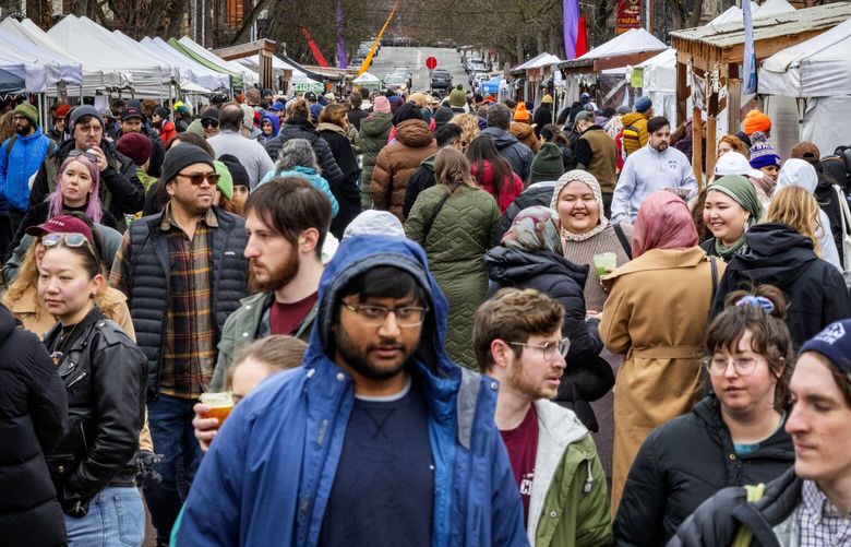 Cold rainy weather does not stop crowds from visiting Ballard Farmers Market, Sunday, March 3, 2024 in Seattle.
