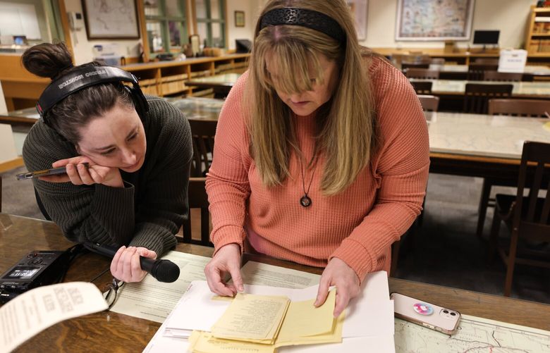 Reporter Sydney Brownstone and Carrie Davidson, look for evidence of Lillian Hansen, her great-grandmother who was a patient at the Northern State Hospital, at the Washington State Archives in Olympia on Friday, March 24, 2023. Carrie Davidson’s grandfather never knew why he had been adopted – he assumed his mother didn’t want him. Turns out she was a patient at Northern State, sent there after she was raped as a teenager, wed to her rapist and contracted syphilis from him. She died there, too. Closed records are now available for viewing for the first time.