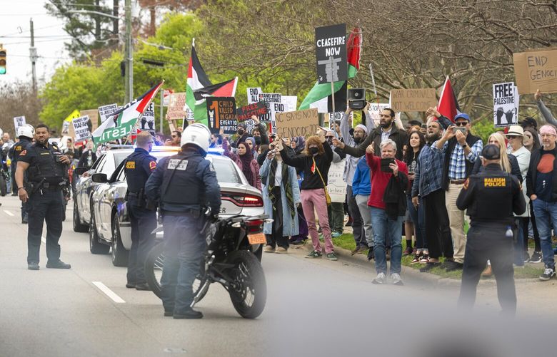 Pro-Palestinian protesters greet President Joe Biden’s motorcade as he arrives for an event at the John Chavis Community Center in Raleigh, N.C., on Tuesday, March 26, 2024. President Joe Biden and Harris highlighted their administration’s work on expanding access to affordable health care as Democrats seek a contrast with Republicans on the issue.  (Doug Mills/The New York Times) XNYT0573 XNYT0573