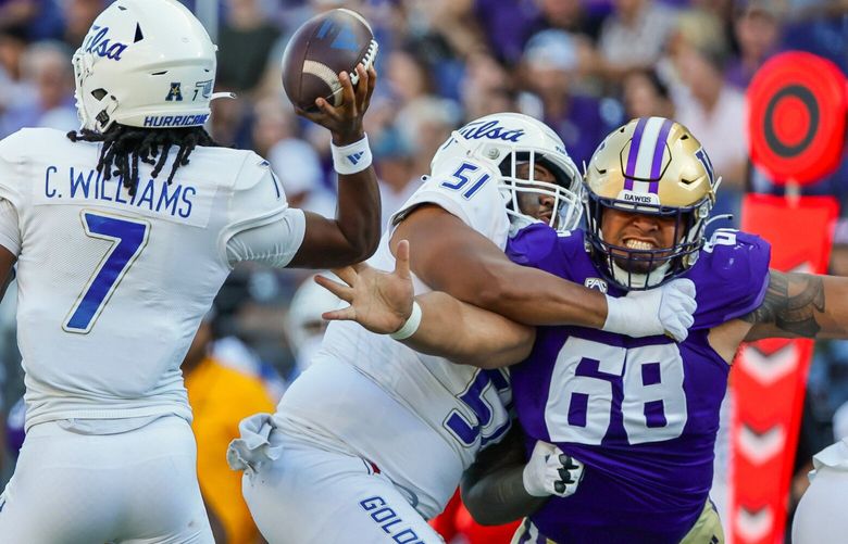 Despite the block from Tulsa Golden Hurricane offensive lineman Tautai Lio Marks, Washington Huskies defensive lineman Ulumoo Ale gets to the elbow of quarterback Cardell Williams forcing an incompletion during the second quarter Saturday, Sept. 9, 2023 in Seattle. 224933 224933