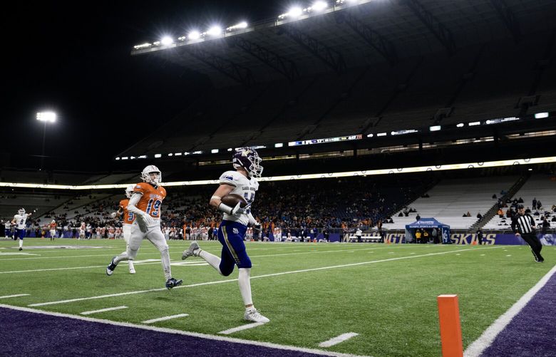 Lake Stevens senior Jesse Lewis runs in for a touchdown Sunday, Dec. 3, 2023, during the 4A state football championship at Husky Stadium in Seattle. Undefeated Graham-Kapowsin took on 12-1 Lake Stevens in the 4A title game as both teams looked to become state champions.