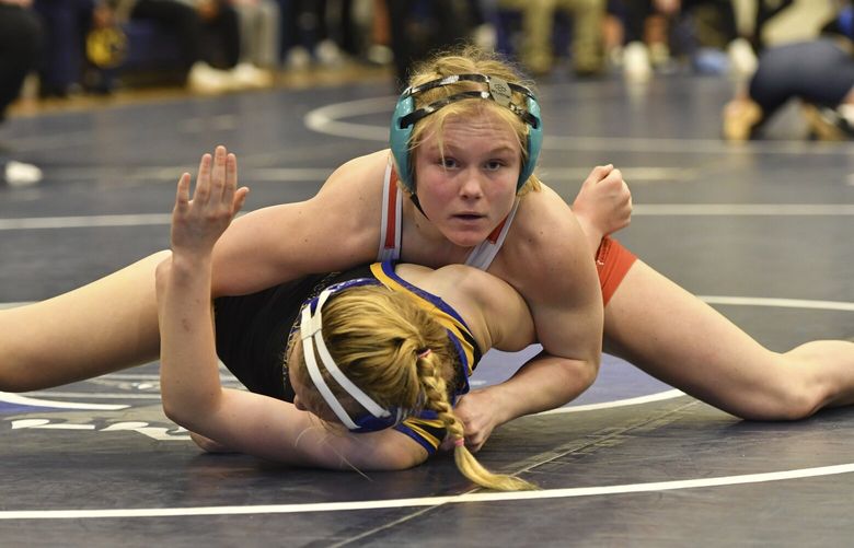 Easton Area High School wrestler Aubre Krazer, top, competes in a semifinal match during the Southeast Regional wrestling tournament Sunday, Feb. 25, 2024, in Quakertown, Pa. Girls’ wrestling has become the fastest-growing high school sport in the country. (AP Photo/Marc Levy) RPML104 RPML104