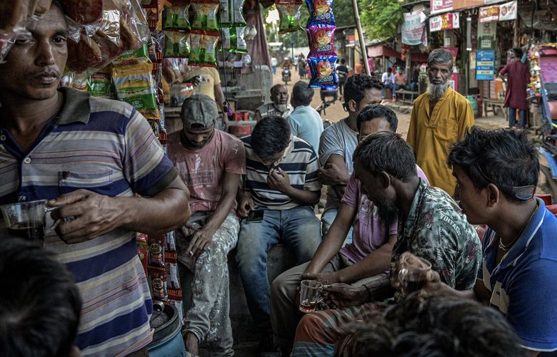 — EMBARGO: NO ELECTRONIC DISTRIBUTION, WEB POSTING OR STREET SALES BEFORE 12:01 A.M. ET ON TUESDAY, APRIL 2, 2024. NO EXCEPTIONS FOR ANY REASONS — FILE — Garment factory workers after their shift in Dhaka, Bangladesh, on July 15, 2023. The country built its success on turning farmers into textile workers. (Atul Loke/The New York Times) XNYT0045 XNYT0045