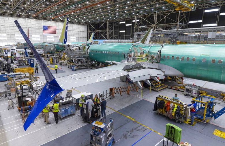 Boeing employees work on the 737 MAX on the final assembly line at Boeing’s Renton plant in 2022. Boeing slowed the assembly line down dramatically as it tried to stabilize production. (Ellen M. Banner / The Seattle TImes, 2022)