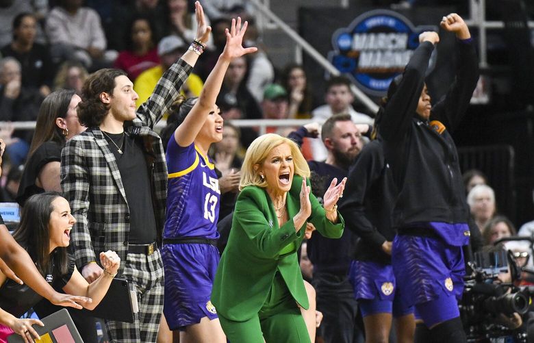 LSU head coach Kim Mulkey and the LSU bench react during the first quarter of an Elite Eight round college basketball game against Iowa during the NCAA Tournament, Monday, April 1, 2024, in Albany, N.Y.