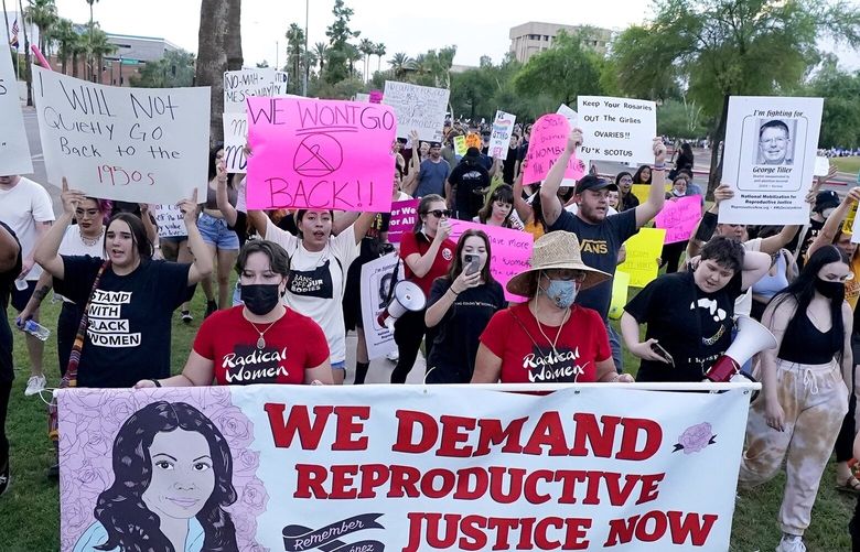 FILE – Thousands of protesters march around the Arizona Capitol in protest after the Supreme Court decision to overturn the landmark Roe v. Wade abortion decision Friday, June 24, 2022, in Phoenix. An Arizona Supreme Court ruling, Tuesday, April 9, 2024,  allowing enforcement of an abortion ban is the latest action to elevate abortion as a key political issue this year. (AP Photo/Ross D. Franklin, File) NY108 NY108