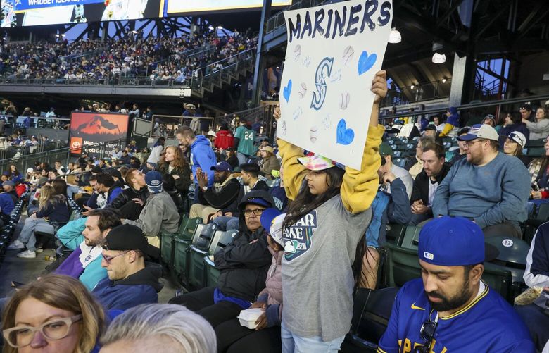 Aisha Mann, 9, of California, holds up a Seattle Mariners sign during a game against the Chicago Cubs at T-Mobile Park in Seattle on Friday, April 12, 2024.

 226644