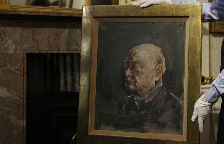 A member of staff from Sotheby’s poses for the media with a portrait of the iconic former British Prime Minister Winston Churchill, painted by Graham Sutherland in 1954, at Blenheim Palace, Woodstock, England, Tuesday, April 16, 2024. The portrait will be sold at auction on June 6 with an estimated price of 500-800,000 pounds sterling (US621, 000-1,000,000). Churchill was born at Blenheim Palace on Nov. 30, 1874. (AP Photo/Alastair Grant) XAG107 XAG107