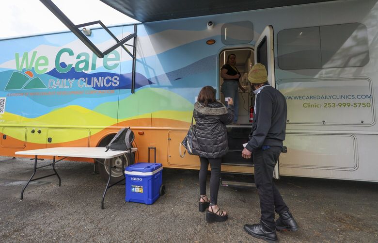 Patients arrive at a mobile We Care Daily Clinics operation providing medical treatment services for people experiencing homelessness and attempting to recover from opioid use, in the parking lot of Recovery Cafe Sodo in Seattle on Monday, April 15, 2024.

 226665