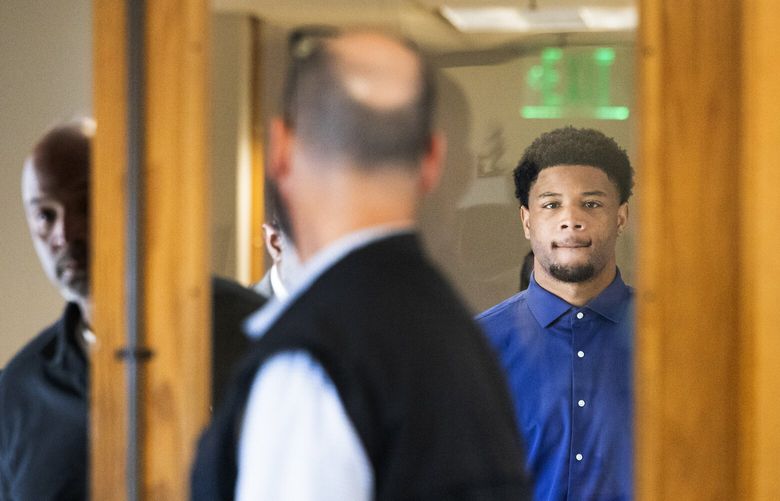Tylin “Tybo” Rogers, right, walks toward a King County courtroom for his arraignment where Rogers pled not guilty to two alleged rape charges, Thursday, April 18, 2024 in Seattle.