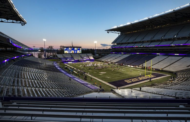 HUSKIES FILE 
The winter sunset glows pink and blue just before kickoff for the University of Washington Huskies and the Utah Utes at Husky Stadium in Seattle Saturday November 28, 2020. 215768