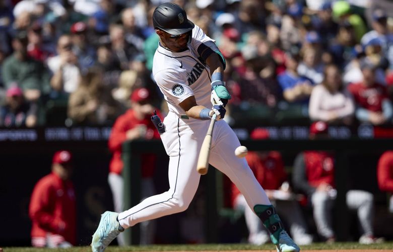 Seattle Mariners’ Julio Rodríguez hits a ground rule double during the third inning of a baseball game against the Cincinnati Reds, Wednesday, April 17, 2024, in Seattle. (AP Photo/John Froschauer) WAJF108 WAJF108