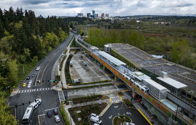 With downtown Bellevue in the distance, Sound Transit operators test a rail car’s braking characteristics, during a recent test stop at South Bellevue Station. (Ken Lambert / The Seattle Times)