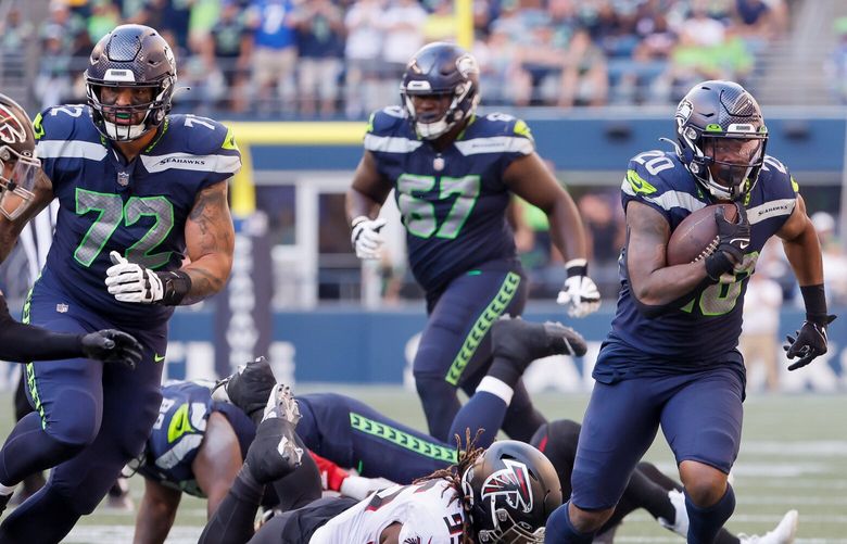 Seattle Seahawks linemen Abraham Lucas (72), Charles Cross (67) and Gabe Jackson (66) flank running back Rashaad Penny as he runs up field on the screen during the fourth quarter, Sunday, Sept. 25, 2022, in Seattle. 221653
