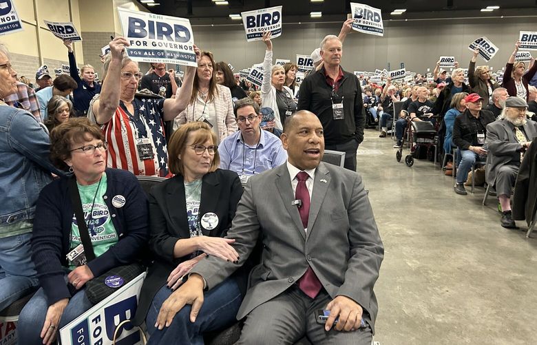 Republican gubernatorial candidate Semi Bird, seated, center right, and supporters react to news that the WA GOP will not be endorsing a candidate for governor Friday April 19, 2024 at the state GOP convention in Spokane.