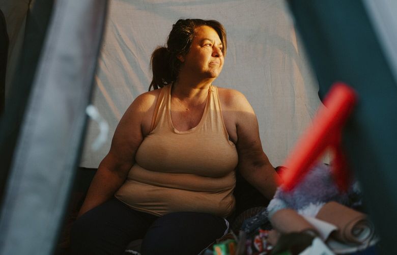 Laura Gutowski, who became homeless after her husband’s death left her without a steady income, in her tent at Fruitdale Park in Grants Pass, Ore., March 19, 2024. The U.S. Supreme Court on Monday, April 22, will take up a lawsuit by a group of homeless residents of the small Oregon town of Grants Pass that could reshape the way cities across the country deal with homelessness. (Mason Trinca/The New York Times) XNYT0274 XNYT0274