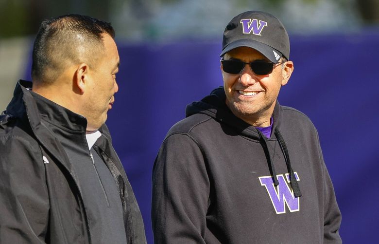 Washington coach Jedd Fisch talks with Athletic Director Pat Chun during practice Tuesday.  Washington held spring practice Tuesday, April 16, 2024. 226664
