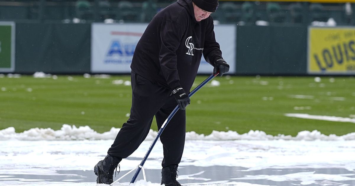Snow blankets Coors Field before chilly MarinersRockies game in Denver