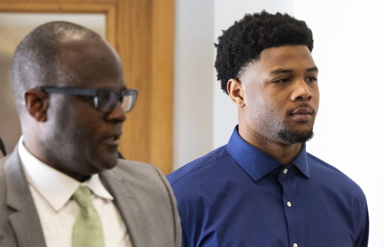 Tylin “Tybo” Rogers, right, walks with his attorney Robert Flennaugh II to an arraignment where Rogers pled not guilty to two alleged rape charges, Thursday, April 18, 2024 in Seattle. “He plans to fight every inch of these false claims,” Flennaugh said in a statement.
