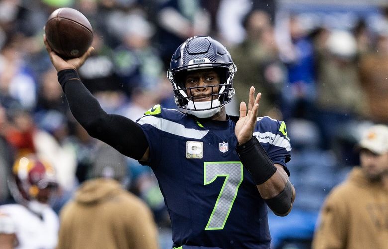 Seattle Seahawks quarter back Geno Smith warms up on the field and passes the ball Sunday, Nov. 12, 2023, as the Seahawks host the Commanders at Lumen Field in Seattle.