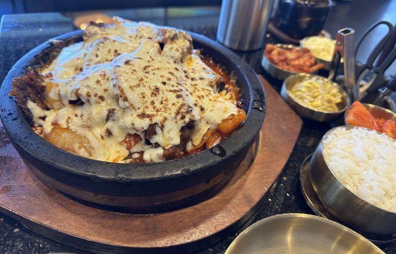 The braised beef short rib kalbijjim at Daeho is a thick, spicy/sweet stew with rice cakes, carrots, radish, potato and hunks of tender bone-in short rib, topped with melted cheese.