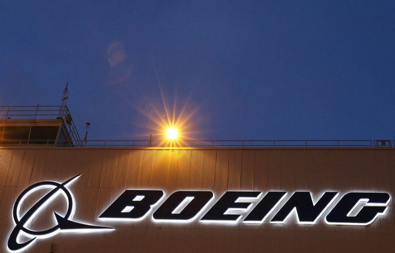 FILE – An airplane flies over a sign on Boeing’s 737 delivery center, Oct. 19, 2015, at Boeing Field in Seattle. Boeing will be in the spotlight during back-to-back hearings Wednesday, April 17, 2024, as Congress examines allegations of major safety failures at the embattled aircraft manufacturer. (AP Photo/Ted S. Warren, File) NYSS210 NYSS210