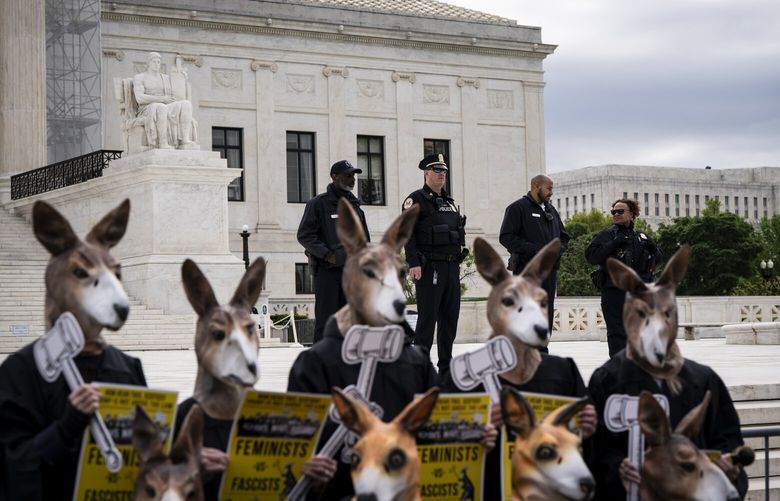 Nine people dressed in judges robes and kangaroo masks protest outside the Supreme Court in Washington, on Thursday, April 25, 2024. The Supreme Court, in its last argument of the term, is considering on Thursday whether former President Donald Trump must face trial on charges that he plotted to subvert the 2020 election. (Haiyun Jiang/The New York Times) XNYT0821 XNYT0821