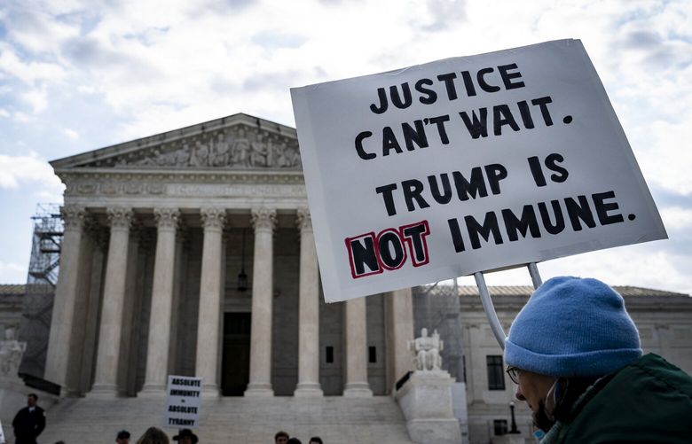 Protesters demonstrating against the argument that former President Donald Trump has “absolute immunity” outside the Supreme Court in Washington, on Thursday, April 25, 2024. The Supreme Court, in its last argument of the term, is considering on Thursday whether former President Donald Trump must face trial on charges that he plotted to subvert the 2020 election. (Haiyun Jiang/The New York Times) XNYTF XNYTF