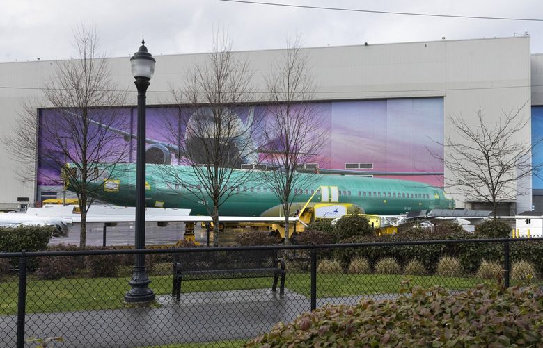 A Boeing worke walks outside of the Boeing Renton Factory in Renton past a MAX fuselage sitting on a train Friday, March 1, 2024.  Boeing may buy Spirit, restoring the Wichita unit it sold 20 years ago
 226304