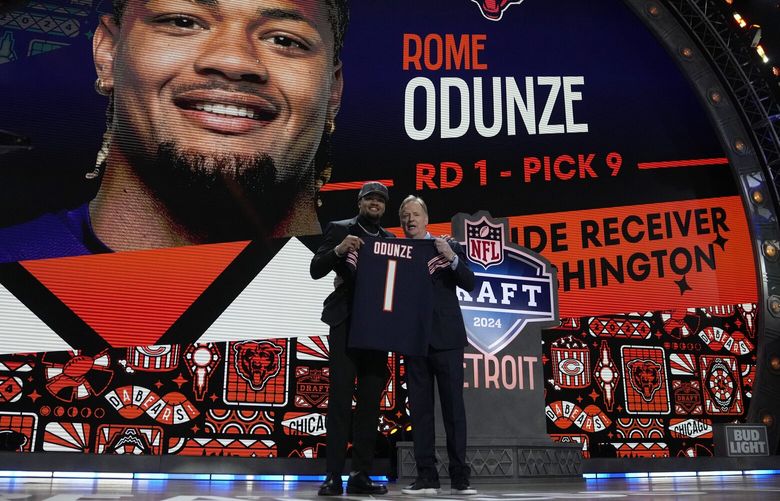 Washington wide receiver Rome Odunze, left, poses with NFL Commissioner Roger Goodell after being chosen by the Chicago Bears with the ninth overall pick during the first round of the NFL football draft, Thursday, April 25, 2024, in Detroit. (AP Photo/Jeff Roberson) MIJL254 MIJL254