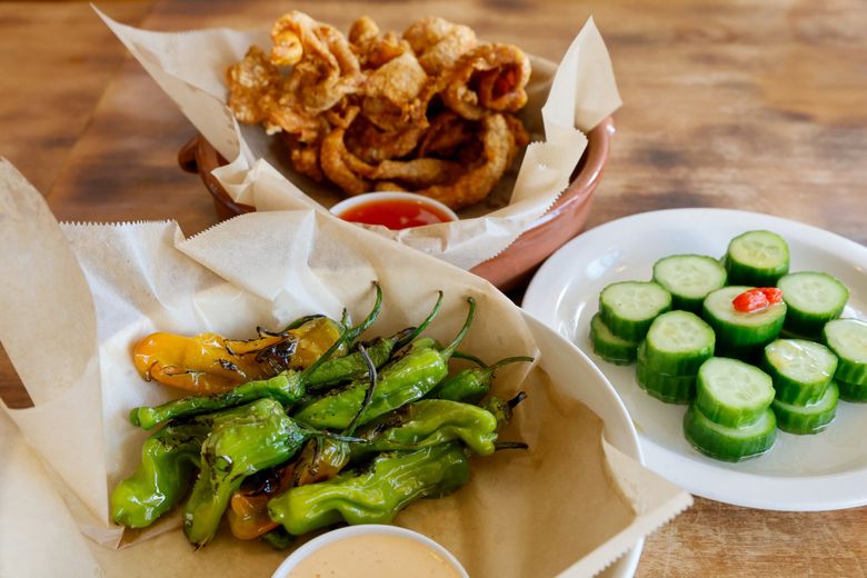 There are just three appetizers at Ginger & Scallion: shishito peppers, fried chicken skins and the cucumber salad. (Jennifer Buchanan / The Seattle Times)