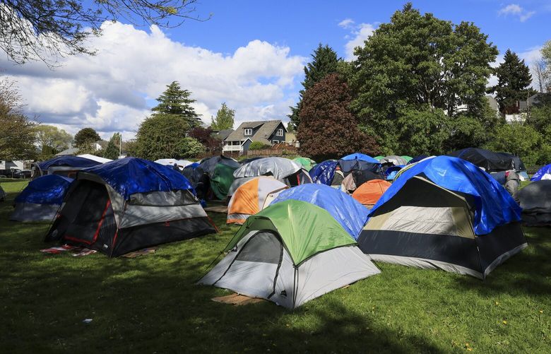 Asylum seekers without access to shelter stay in tents at Powell Barnett Park in Seattle  on Tuesday, April 30, 2024. Over 200 people including children and families set up tents Monday’s rainy afternoon, and slept at the park overnight.  226763