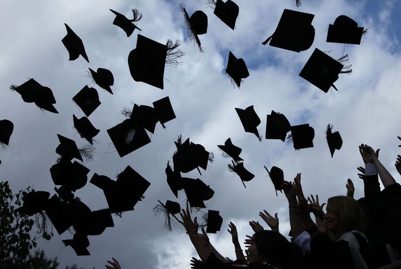 Students throw their mortarboards in the air during their graduation photograph at the University of Birmingham degree congregations on July 14, 2009, in Birmingham, England. (Christopher Furlong/Getty Images North America/TNS)