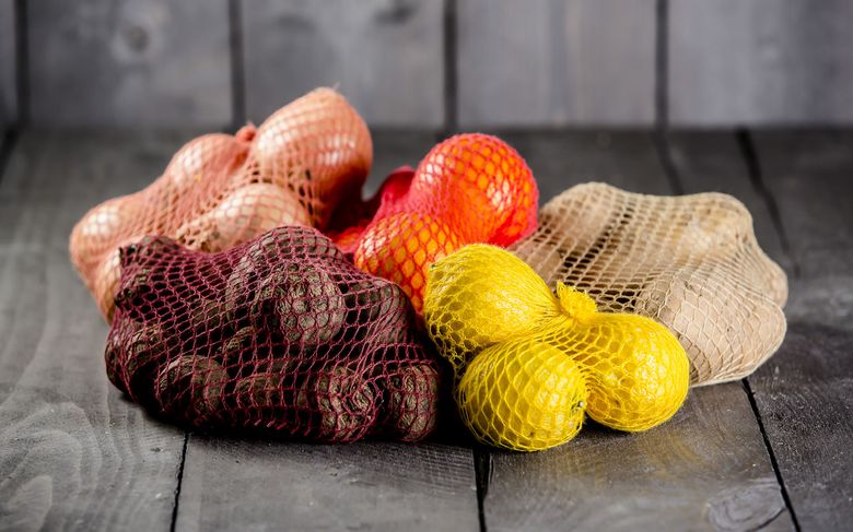 Biodegradable cellulose net bags, created by an Austrian company using beechwood trees, are ideal for holding produce. As governments impose limits on plastic food packaging, climate-friendlier alternatives are in the works. (VPZ Verpackungszentrum GmbH via The New York Times)