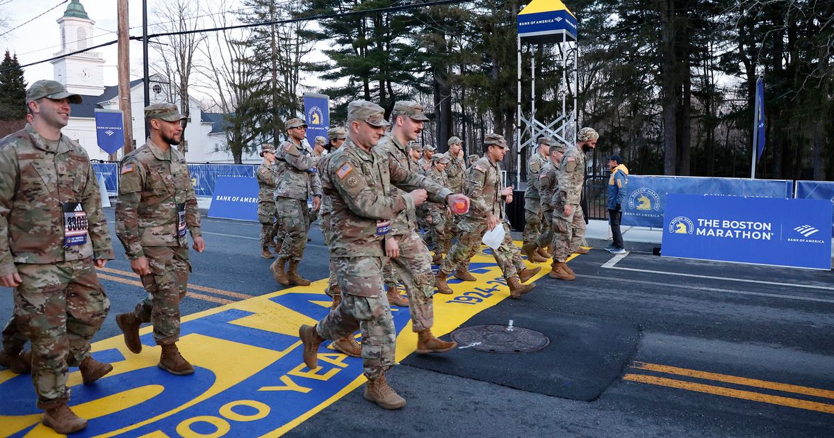Military marchers set out from Hopkinton to start the 128th Boston Marathon