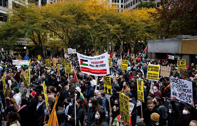 Protesters rally in Westlake Park Saturday, Oct. 21, 2023, in Seattle.