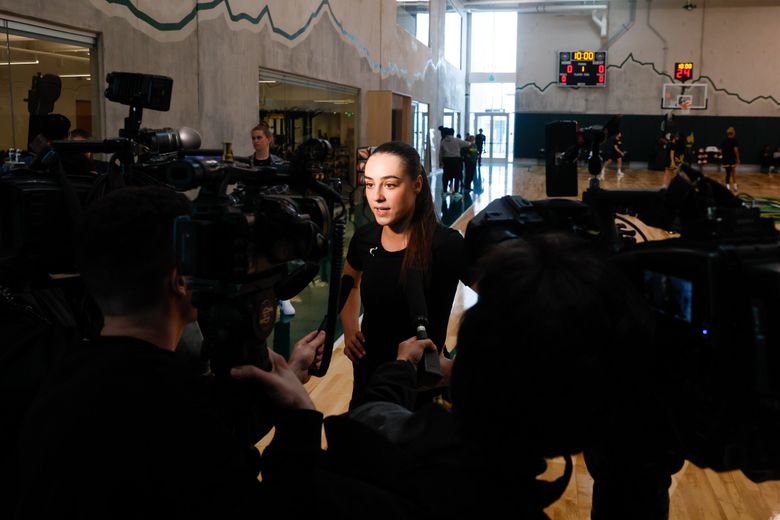 Seattle Storm guard Nika Mühl gives a television interview after the first day of training camp, April 28, 2024 in Seattle.  (Jennifer Buchanan / The Seattle Times)