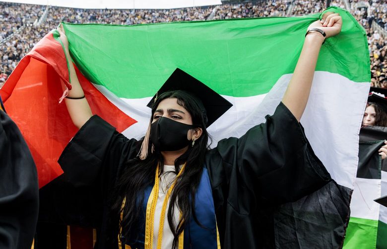 Pro-Palestinian protesters demonstrate during the University of Michigan’s Spring 2024 Commencement Ceremony at Michigan Stadium in Ann Arbor, Mich., on Saturday, May 4, 2024.( Jacob Hamilton/Ann Arbor News via AP) MIARB111 MIARB111