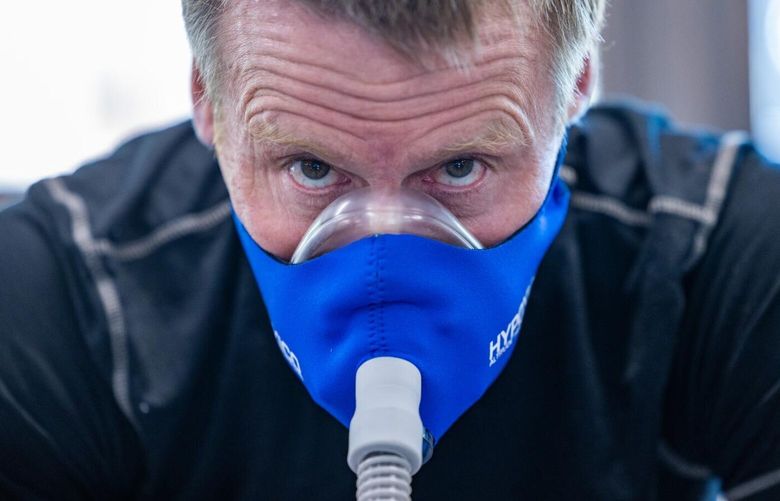 Truckee, CA – April 18: Graham Cooper exercises a training mask connected to an altitude generator for low oxygen training to prepare for an ascent of Mt. Everest on Thursday, April 18, 2024 in Truckee, CA. (Brian van der Brug / Los Angeles Times)