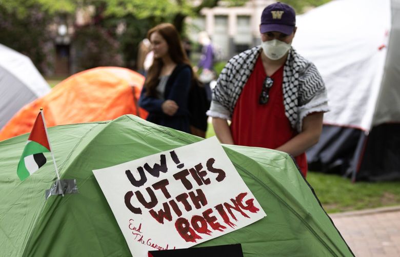 Students rearrange a tent inside of a “liberated zone for Palestinian solidarity” in the Quad at the University of Washington on Friday, May 3, 2024, in Seattle.