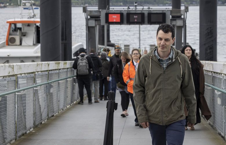 Jordan Lewis, a landscape architect, walks from the Bremerton fast ferry (at left) at Pier 50 Wednesday, April 24, 2024.  He left Seattle in 2019 because he couldn’t find an affordable home to purchase and moved to Bremerton, where he was able to buy a home.

Rising housing costs in Seattle-area are pushing would-be home-owners to leave for less costly communities â€” or even less costly states.

Some are retirees looking for a less burdensome mortgage. But others are younger, would-be first-time buyers who simply canâ€™t figure how to stay in Seattle and still have the dream of owing a home.

Higher housing prices have changed not only how people live, but where â€” and what these changes mean for the Seattle areaâ€™s economy, demography and future. 226716