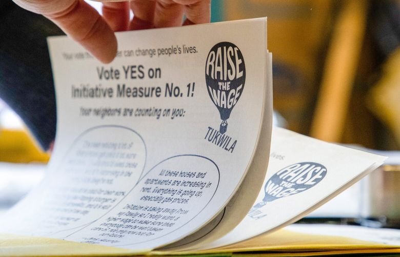 Katie Wilson sorts a folder of informational handouts for Raise the Wage Tukwila in the Riverton Park United Methodist Church on Friday, Oct. 21, 2022. The group is working to rally a large turnout of voters in support of a measure to raise Tukwila’s minimum wage. 221921