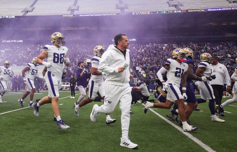 Jedd Fisch runs on to the turf of Husky Stadium for Friday’s Spring Game.  The University of Washington Huskies played its Spring Game Friday, May 3, 2024 under the lights of Husky Stadium. 226774