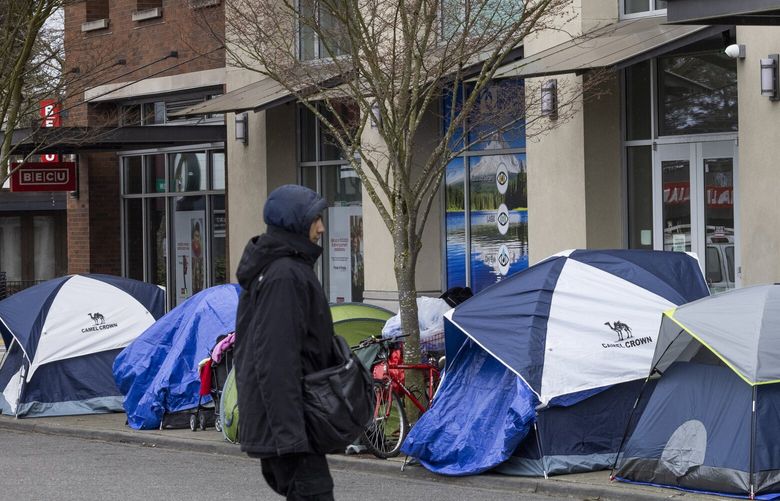 A man heads towards the tents along 5th Ave. SW near SW 152nd St. in Burien Monday, March 11, 2024 Monday, March 11, 2024.  People were allowed to camp there from 7 p.m. until 6 a.m. but Monday things changed and currently they can camp on the sidewalk 24 hours a day.  

King County will be announcing more news today related to Burien’s recently tightened camping law.

 226407