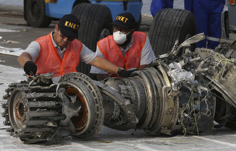 Officials inspect an engine recovered the crashed Lion Air jet in Jakarta, Indonesia, on Nov. 4, 2018. A then-new Boeing 737 MAX 8 jet plunged into the Java Sea just minutes after takeoff from Jakarta early on Oct. 29, 2018, killing all on board. (Achmad Ibrahim / AP)