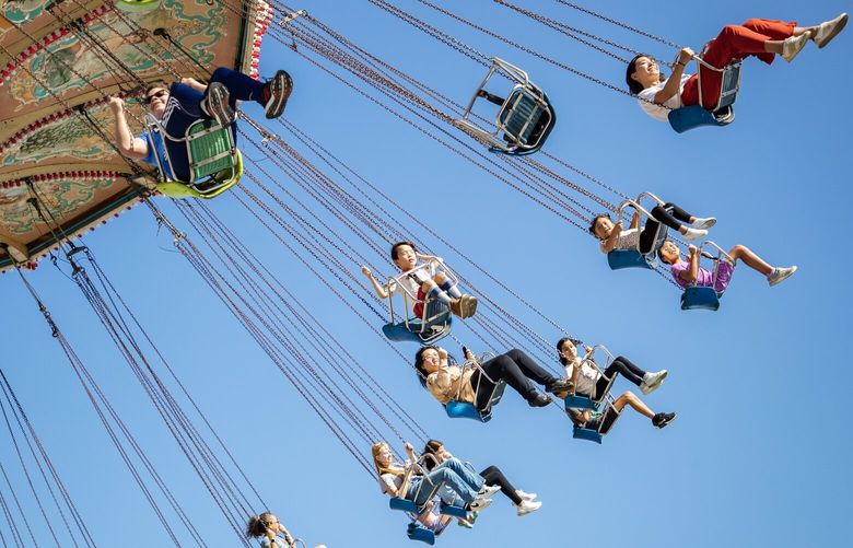 People ride the chair swing ride Friday, Sept. 1, 2023, at the Washington State Fair in Puyallup.