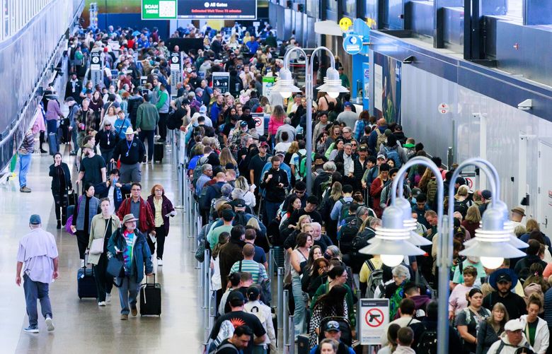 Passengers wait in line at Security Checkpoint 2 at Seattle-Tacoma International Airport Tuesday, May 14, 2024. Security Checkpoint 3 closed down Sunday, and will be closed about a month. Security Checkpoint 2 opened on Saturday, which had been closed for the previous month for reconfiguration. Both checkpoints are adding more lanes for security screening.  
 226909